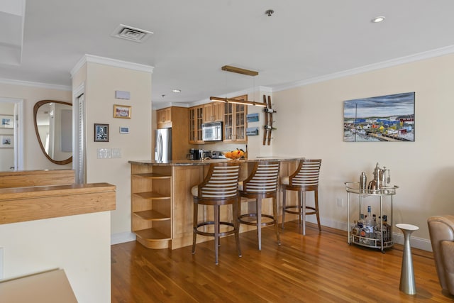 bar with stainless steel refrigerator, crown molding, and dark wood-type flooring