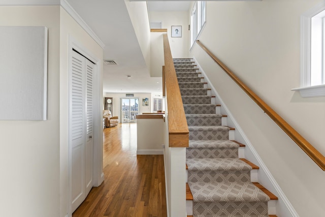 stairway with hardwood / wood-style floors