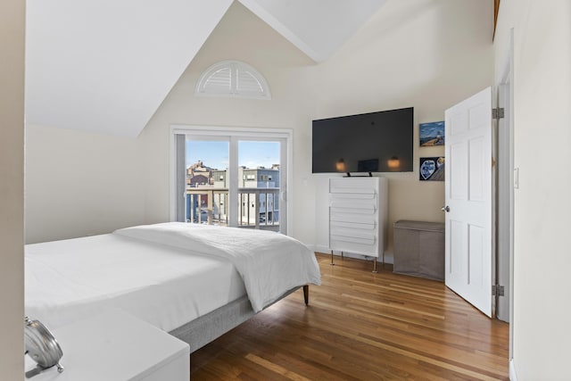 bedroom with hardwood / wood-style floors, high vaulted ceiling, and access to outside