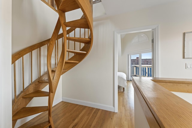 stairway featuring wood-type flooring