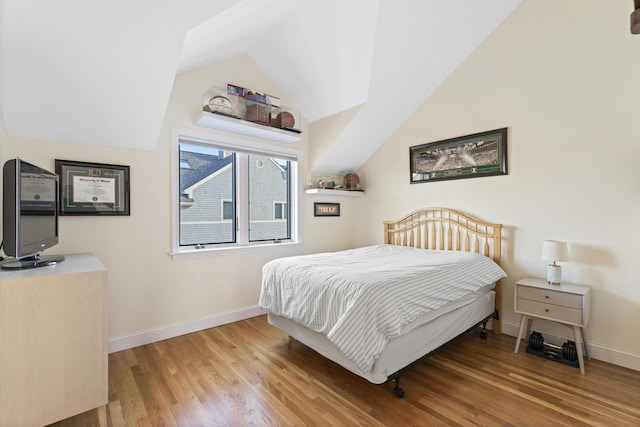 bedroom featuring light hardwood / wood-style flooring and lofted ceiling