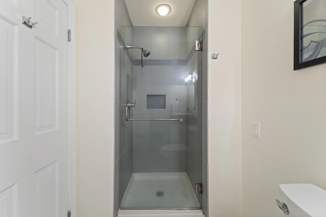 bathroom with toilet and walk in shower