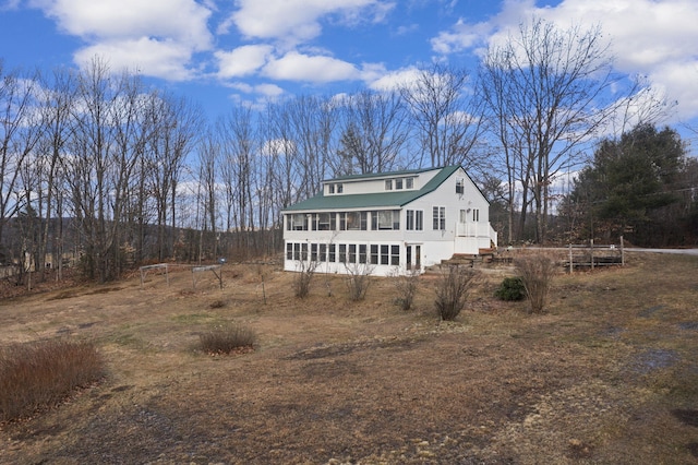 view of front of house featuring a sunroom and a trampoline