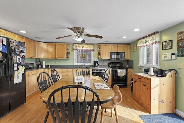 kitchen featuring black appliances, sink, ceiling fan, light brown cabinetry, and light hardwood / wood-style floors