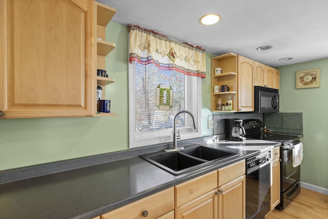 kitchen with light brown cabinets, black appliances, sink, tasteful backsplash, and light hardwood / wood-style floors