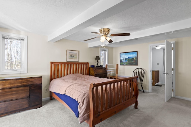 carpeted bedroom with ceiling fan, beamed ceiling, and a textured ceiling