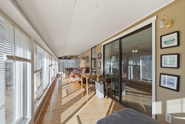 sunroom with ceiling fan, plenty of natural light, and wood ceiling