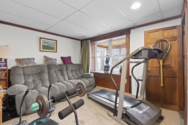 exercise room featuring a paneled ceiling and crown molding