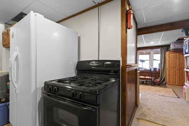 kitchen with light carpet, gas stove, white refrigerator with ice dispenser, and a paneled ceiling