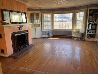 unfurnished living room featuring dark hardwood / wood-style floors