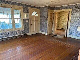 foyer featuring dark hardwood / wood-style flooring and crown molding