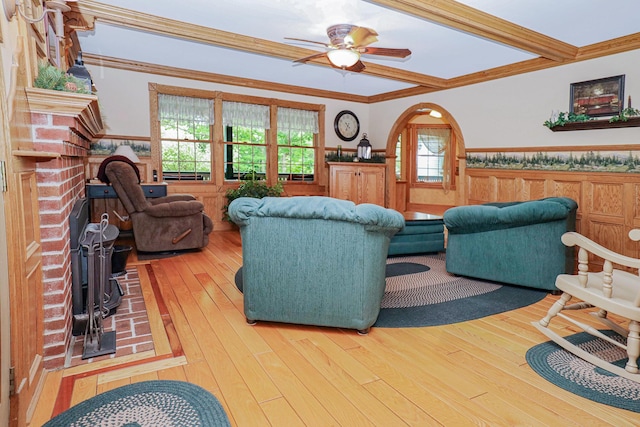 living room featuring a wainscoted wall, ceiling fan, hardwood / wood-style floors, and crown molding