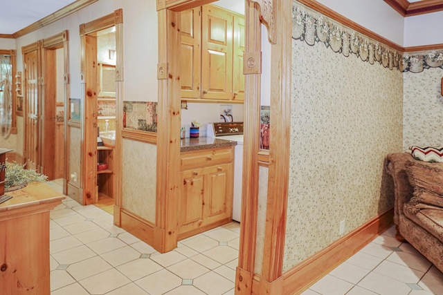 hall featuring wallpapered walls, light tile patterned floors, washer / clothes dryer, and crown molding