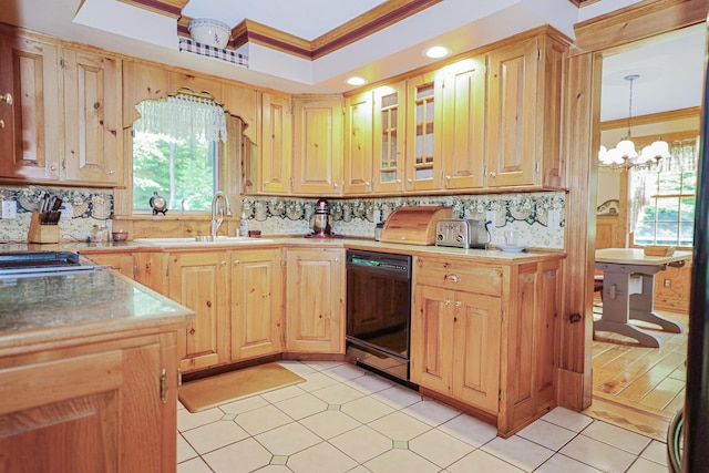 kitchen with a sink, black dishwasher, ornamental molding, tasteful backsplash, and a raised ceiling