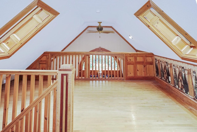 bonus room with lofted ceiling, light wood finished floors, and a ceiling fan