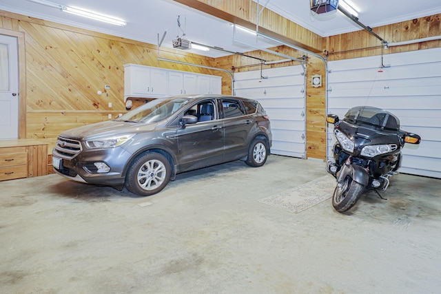 garage featuring wood walls and a garage door opener