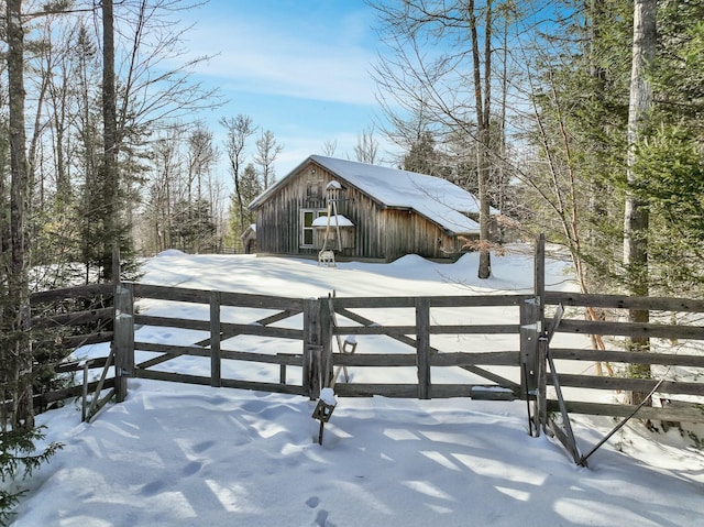 exterior space featuring an outbuilding, a gate, and fence