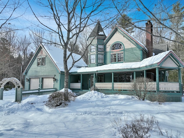 victorian home with a chimney and a porch