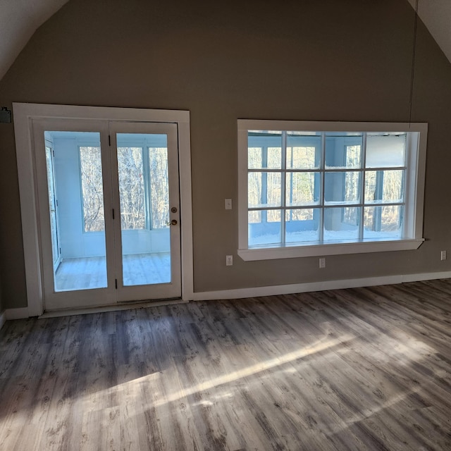 doorway to outside featuring dark wood-type flooring and vaulted ceiling