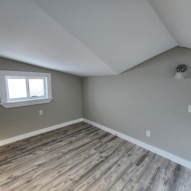 bonus room featuring light hardwood / wood-style flooring and vaulted ceiling