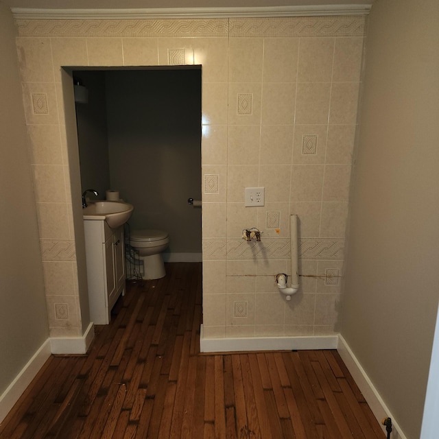 bathroom featuring hardwood / wood-style flooring, vanity, and toilet