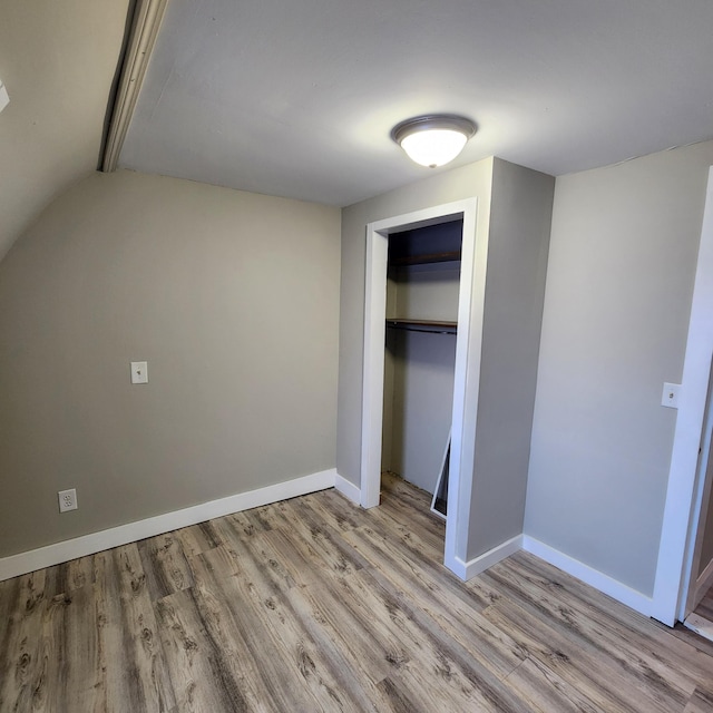 unfurnished bedroom with a closet and light hardwood / wood-style flooring