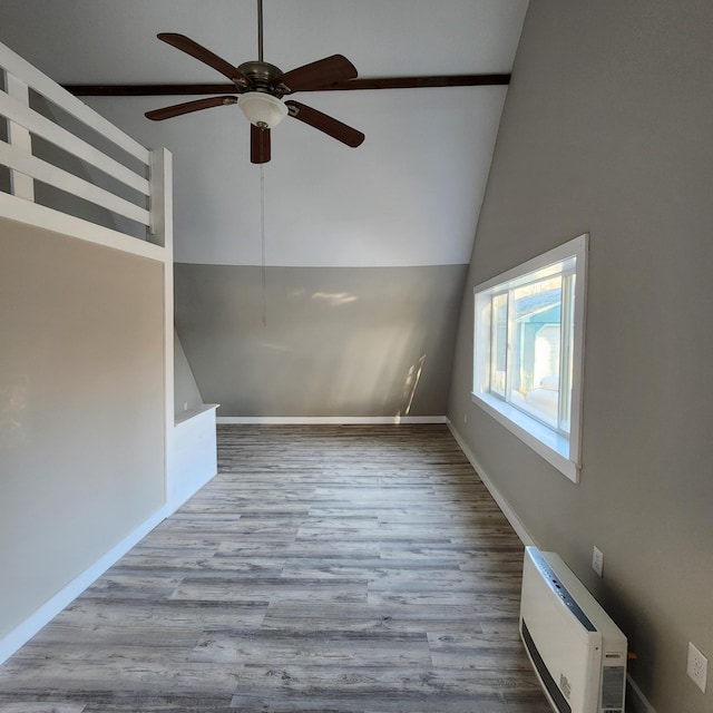 interior space featuring a wall unit AC, ceiling fan, high vaulted ceiling, and light hardwood / wood-style floors