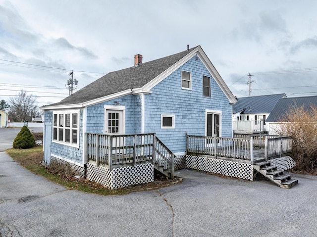 back of property featuring a wooden deck