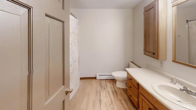 bathroom with wood-type flooring, vanity, a baseboard heating unit, toilet, and a shower with curtain