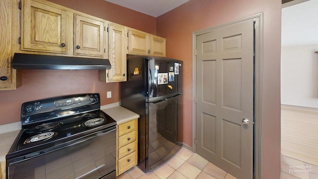 kitchen featuring light tile patterned flooring, light brown cabinetry, and black appliances