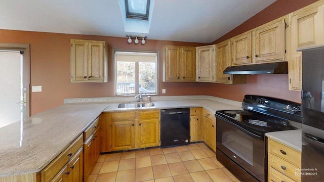 kitchen with light tile patterned flooring, lofted ceiling with skylight, sink, kitchen peninsula, and black appliances