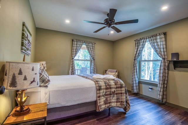 bedroom with ceiling fan and dark hardwood / wood-style flooring