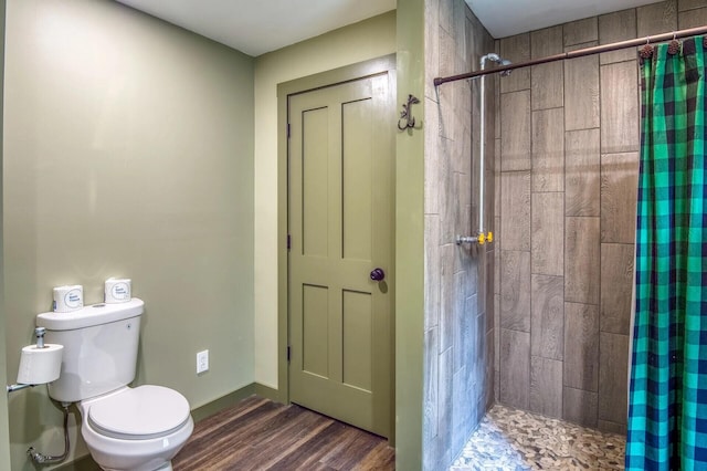 bathroom with toilet, wood-type flooring, and walk in shower