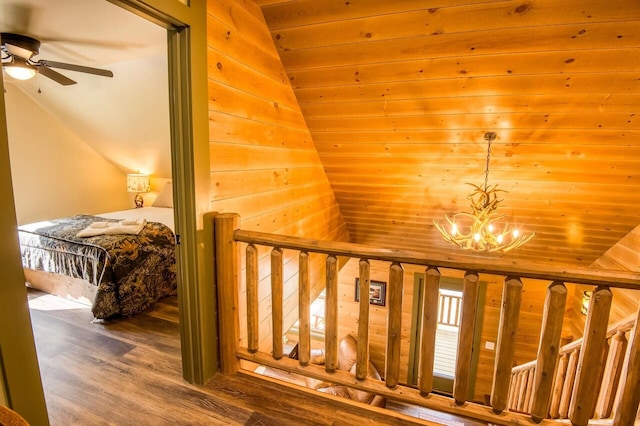 staircase with hardwood / wood-style floors, ceiling fan with notable chandelier, wood ceiling, and lofted ceiling