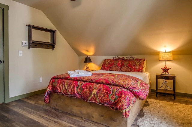 bedroom featuring hardwood / wood-style flooring and vaulted ceiling