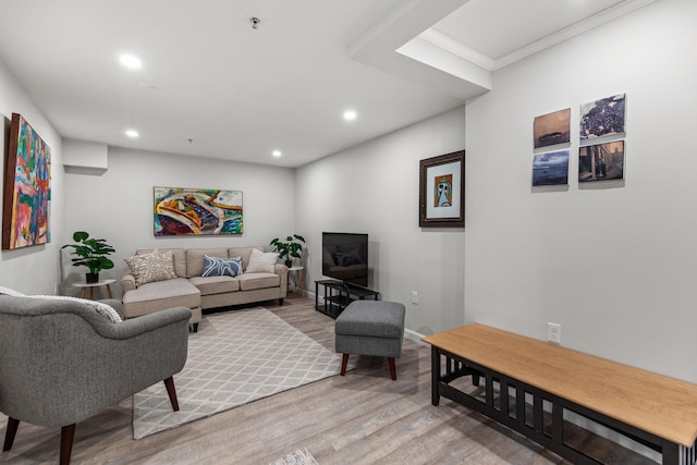 living room with hardwood / wood-style flooring and ornamental molding