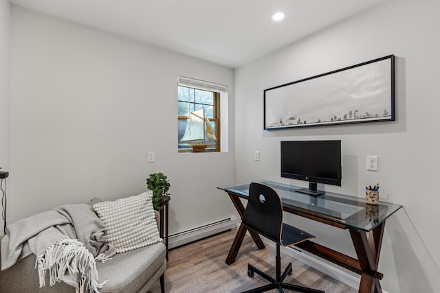 home office with hardwood / wood-style flooring and baseboard heating