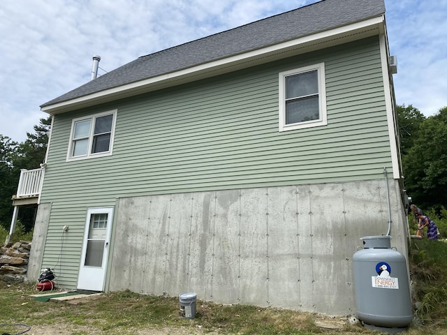 back of property with a shingled roof