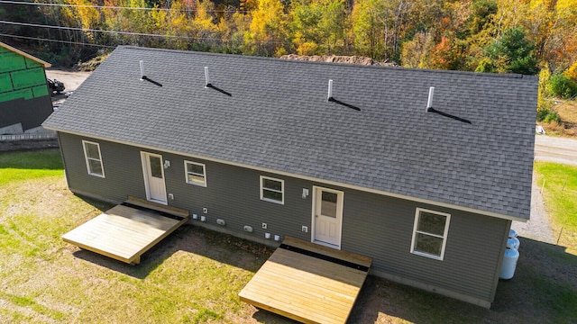 back of house with a lawn