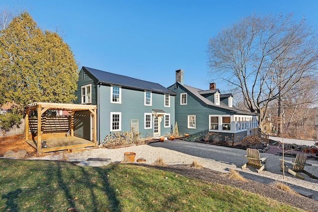 back of house with a yard and a pergola