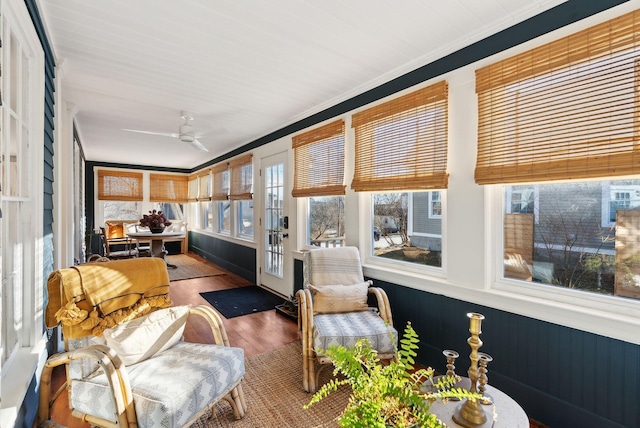 sunroom / solarium featuring ceiling fan