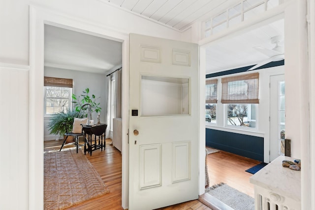 foyer with plenty of natural light, light hardwood / wood-style floors, and lofted ceiling