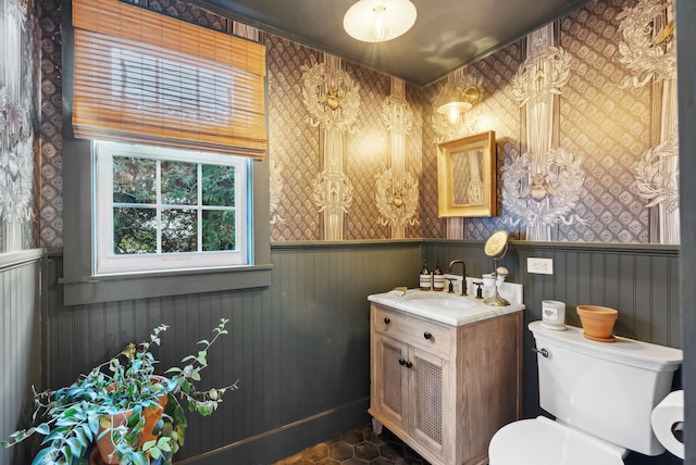 bathroom with tile patterned flooring, vanity, and toilet