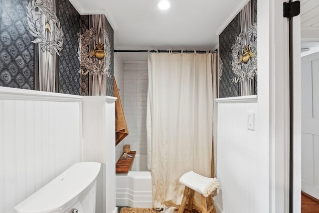 bathroom with shower / bath combination with curtain and toilet