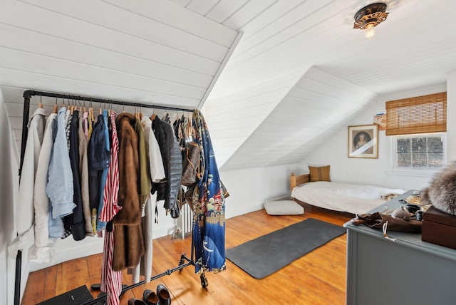 bedroom featuring hardwood / wood-style flooring, wood ceiling, and lofted ceiling