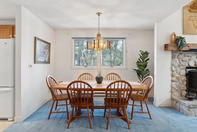 carpeted dining space with an inviting chandelier