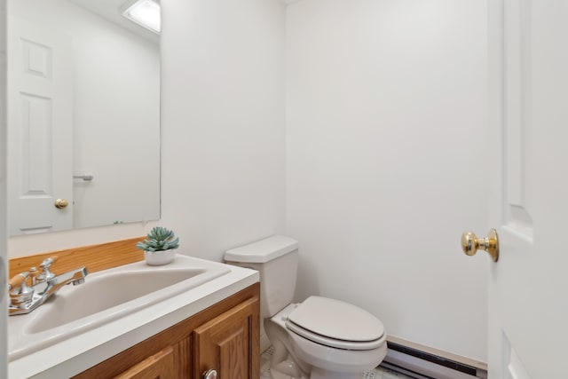 bathroom featuring baseboard heating, vanity, and toilet