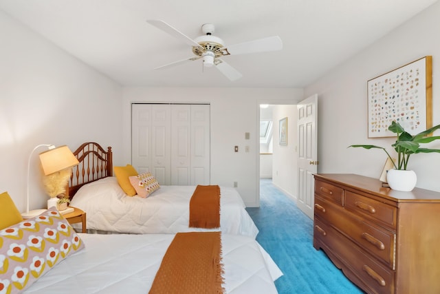 carpeted bedroom with a closet and ceiling fan