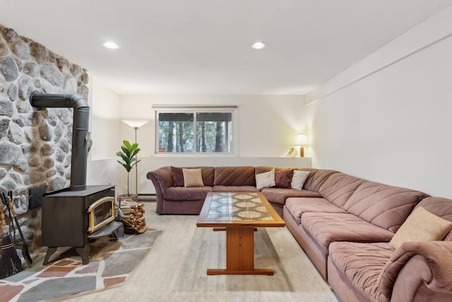 living room with a wood stove and a baseboard heating unit