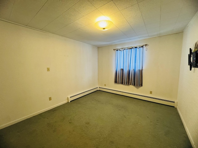 empty room with baseboard heating and dark colored carpet